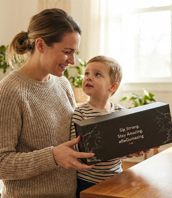 Woman and child holding a box with 'Sip Strong. Stay Amazing BeGumazing' text.